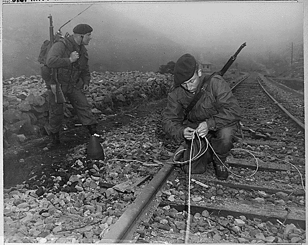 Commandoes of the 41st Royal British Marines plant demolition charges along railroad tracks of enemy supply line which they demolished during a commando raid, 8 miles south of Songjin, Korea., 04/10/1951. Credit: National Archives