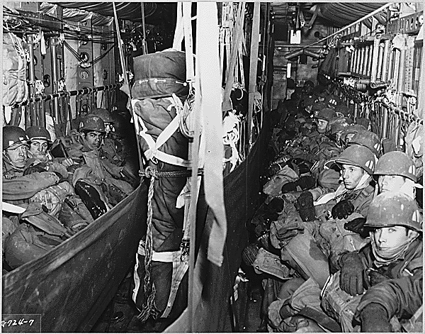 Paratroopers of the 187th Airborne Regimental Combat Team, seated in the cargo compartment of 314th Troop Carrier Group C-119 “Flying Boxcar,” “sweat out” the flight to the dropzone at Munsan-ni, Korea, in March, 1951, ca. 03/1951. Credit: National Archives