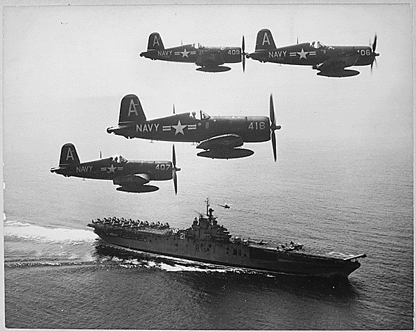 F4U’s (Corsairs) returning from a combat mission over North Korea circle the USS Boxer as they wait for planes in the next strike to be launched from her flight deck-a helicopter hovers above the ship., 09/04/1951. Credit: National Archives
