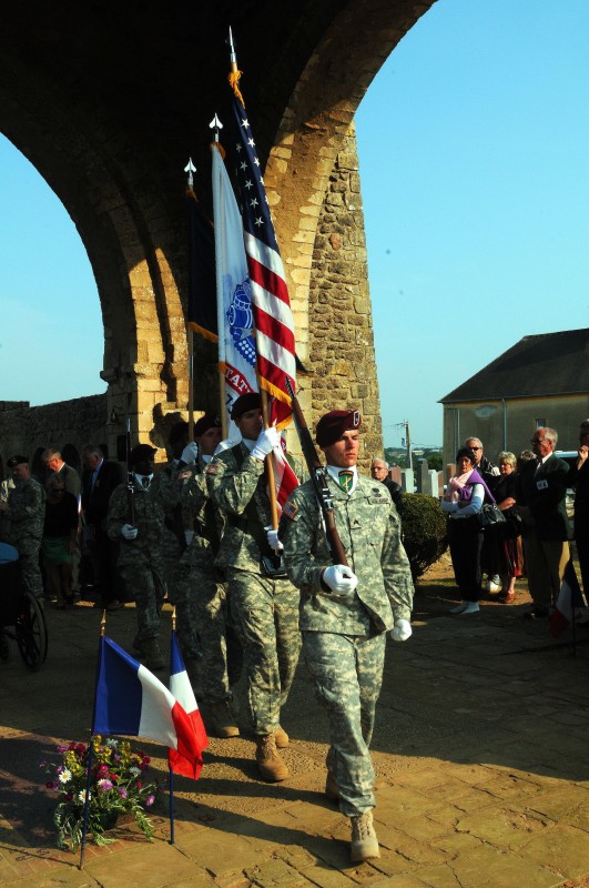 Spectators watch as U.S. Army Airborne soldiers from various unit throughout Europe and Italy, including the 21st Theater Sustainment Command’s 5th Quartermaster Detachment, march through the Graignes Cemetery after a memorial ceremony in Graignes, France, June 4. The ceremony was held to honor the U.S. soldiers and citizens of Graignes who gave their lives in defense of the town during the period of June 6-12, 1944. During the ceremony 10 wreathes were laid by various city officials, veterans and U.S. Army soldiers. This ceremony was one of many World War II commemoration ceremonies held this year to honor the soldiers who fought during the invasion of Normandy, France, in 1944. Credit: Staff Sgt. Michael Taylor, DVIDSHUB.