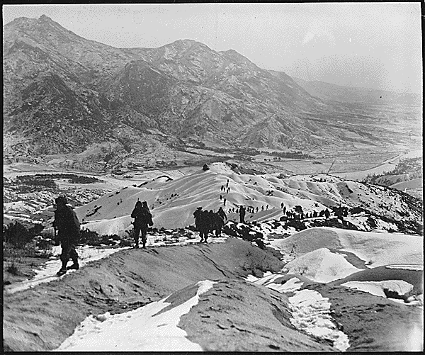 Men of the 19th Infantry Regiment work their way over the snowy mountains about 10 miles north of Seoul, Korea, attempting to locate the enemy lines and positions., 01/03/1951. Credit: National Archives