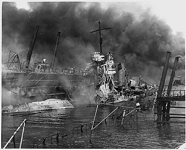The twisted remains of the destroyer USS SHAW burning in floating drydock at Pearl Harbor after the "sneak Japanese attack" on Dec. 7, 1941. Photo and caption: National Archives.