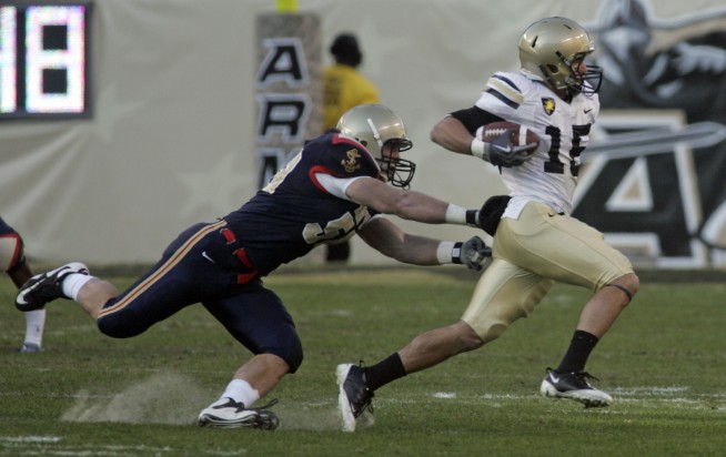 PHILADELPHIA (Dec. 12, 2009) Army slot back Jameson Carter (#15) gets past Navy Linebacker Tony Haberer (#50) during the first quarter of the 110th Army-Navy college football game at Lincoln Financial Field in Philadelphia. U.S. Navy photo by Oscar Sosa. Caption: U.S. Navy.