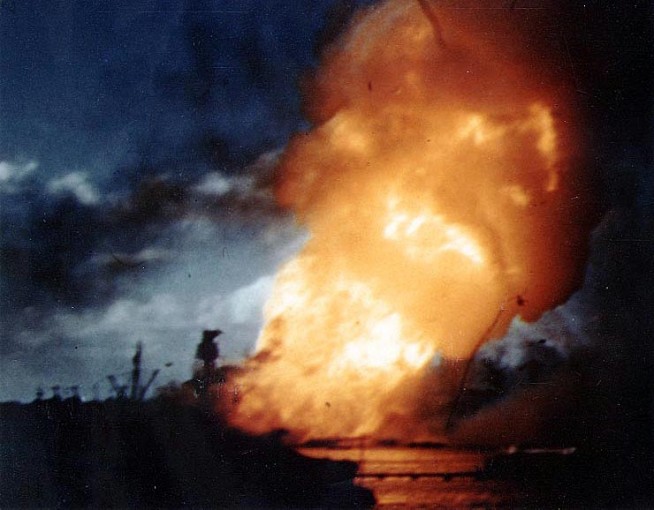 USS Arizona (BB-39) ablaze, immediately following the explosion of her forward magazines, 7 December 1941. Frame clipped from a color motion picture taken from on board USS Solace (AH-5). Official U.S. Navy Photograph, National Archives collection. Caption: Naval History & Heritage Command.