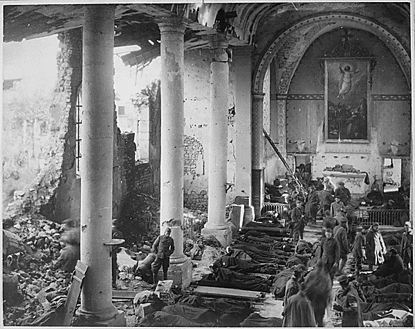 This shattered church in the ruins of Neuvilly furnished a temporary shelter for American wounded being treated by the 110th Sanitary Train, 4th Ambulance Corps. France, September 20, 1918. Credit: National Archives.