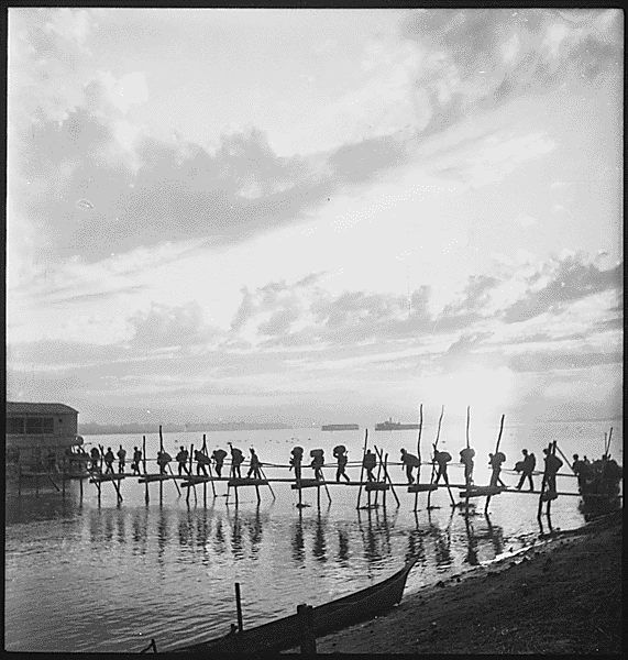 Silhouette of troops at Pandu Ghat. 124th Cavalry Regiment, 5332nd Brigade (Provisional) on move from Ramgarh Training Center to Myitkyina, Burma., 10/25/1944. Credit: National Archives.