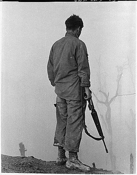 A member of the 5th Infantry Division (Mechanized) Looks out over the fog-shrouded A Shau Valley., 1969. Credit: National Archives.