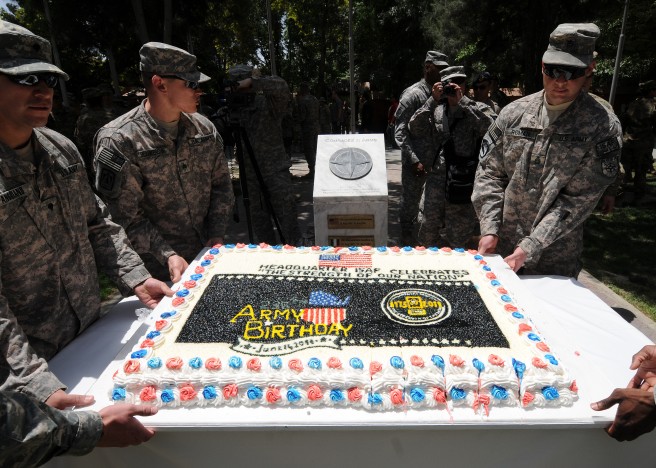 International Security Assistance Force soldiers team-up to move a monster-sized ceremonial birthday cake following an observance ceremony held June 14, 2011 to honor the U.S. Army's 236th birthday. The ceremony took place at ISAF Headquarters located in Kabul, Afghanistan and was attended by approximately 200 soldiers and coalition forces. Army Command Sgt. Maj. Marvin L. Hill, the Command Sergeant Major of the ISAF and U.S. Forces-Afghanistan, spoke about past and present history of today's Army and the importance of the annual observance. Credit: Master Sgt. Michael O'Connor, DVIDSHUB.
