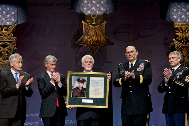 Defense Secretary Chuck Hagel, far left, applauds during a ceremony to induct Medal of Honor recipient Army Chaplain (Capt.) Emil Kapaun into the Hall of Heroes at the Pentagon, April 12, 2013. Ray Kapaun, the chaplain's nephew, represented his uncle, who served in the Korean War, during the ceremony. Army Secretary John M. McHugh, second from left, Army Chief of Staff Gen. Ray Odierno, second from right, and Sgt. Maj. of the Army Raymond F. Chandler III, far right, participated in the ceremony. Image credit: Erin A. Kirk-Cuomo. Caption credit: U.S. Army Flickr feed.