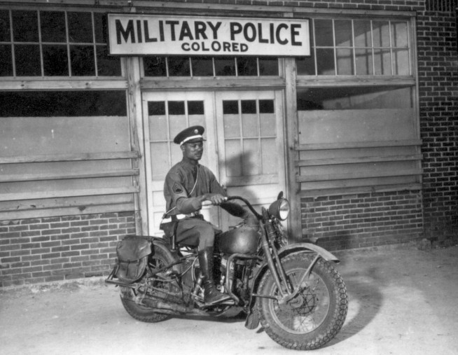 An MP on motorcycle stands ready to answer all calls around his area. Columbus, Georgia." April 13, 1942. Pfc. Victor Tampone. Image and caption credit: National Archives.