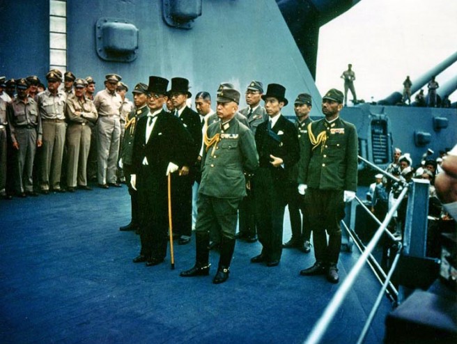 Japanese representatives on board USS Missouri (BB-63) during the surrender ceremonies, 2 September 1945. Standing in front are: Foreign Minister Mamoru Shigemitsu (wearing top hat) and General Yoshijiro Umezu, Chief of the Army General Staff. Behind them are three representatives each of the Foreign Ministry, the Army and the Navy. They include, in middle row, left to right: Major General Yatsuji Nagai, Army; Katsuo Okazaki, Foreign Ministry; Rear Admiral Tadatoshi Tomioka, Navy; Toshikazu Kase, Foreign Ministry, and Lieutenant General Suichi Miyakazi, Army. In the the back row, left to right (not all are visible): Rear Admiral Ichiro Yokoyama, Navy; Saburo Ota, Foreign Ministry; Captain Katsuo Shiba, Navy, and Colonel Kaziyi Sugita, Army. Credit: Naval Historical Center.