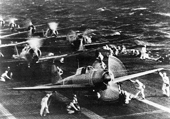 Japanese naval aircraft prepare to take off from an aircraft carrier (reportedly Shokaku) to attack Pearl Harbor during the morning of 7 December 1941. Plane in the foreground is a "Zero" Fighter. This is probably the launch of the second attack wave. The original photograph was captured on Attu in 1943. Official U.S. Navy Photograph, National Archives Collection. Caption: Naval History & Heritage Command.
