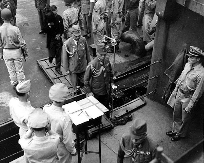 The Japanese delegation comes on board USS Nicholas (DD-449) to be taken to USS Missouri for the surrender ceremonies, 2 September 1945. Most sources state that the Japanese were transported to Missouri by USS Lansdowne (DD-486), while Nicholas carried members of the Allied Powers' delegations. Credit: Naval Historical Center.