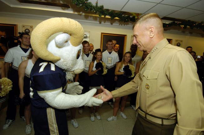 Pentagon, Washington, D.C. (Nov. 30, 2005) – The Commandant of the Marine Corps Gen. Michael Hagee gives the U.S. Naval Academy mascot, "Bill the Goat" his challenge coin after he performed one-arm pushups at the request of Hagee during a Pep-Rally at the Pentagon prior to the upcoming 106th Army-Navy football game. U.S. Navy photo by Mr. Damon Moritz . Caption: U.S. Navy. 