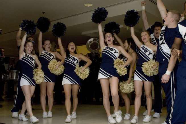 PENTAGON (Nov. 29, 2007) U.S. Naval Academy cheerleaders and band perform during a pep rally in the Pentagon prior to the upcoming Army-Navy game. The Midshipmen take on the Black Knights in the 108th Army-Navy game Saturday in Baltimore. U.S. Navy photo by Mass Communication Specialist 1st Class Tiffini M. Jones. Caption: U.S. Navy.