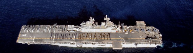 2008: Sailors and Marines aboard the amphibious assault ship USS Boxer spell out "Go Navy, Beat Army!" on the flight deck to cheer on the midshipmen in the upcoming 109th Army-Navy college football game. Photo: Petty Officer 2nd Class Jon Rasmussen. Caption: DVIDSHUB.