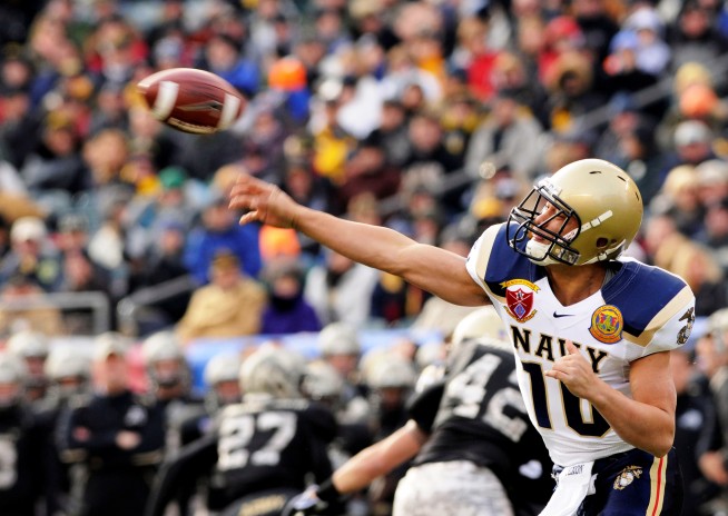 U.S. Naval Academy quarterback Kapo-Noa Kaheaku-Enhada (#10) throws a pass during the 109th Army-Navy college football game at Lincoln Financial Field in Philadelphia. Photo: Petty Officer 2nd Class Tommy Gilligan. Caption: DVIDSHUB. 