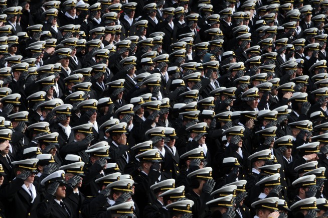 PHILADELPHIA (Dec. 6, 2008) U.S. Naval Academy midshipmen salute during the national anthem before the start of the 109th Army-Navy college football game at Lincoln Financial Field in Philadelphia. (U.S. Navy photo by Mass Communication Specialist 2nd Class Kevin S. O'Brien. Caption: U.S. Navy.