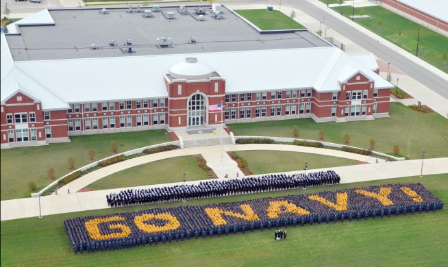 GREAT LAKES, Ill., (Aug. 29, 2009) More than 4,750 recruits and staff members from Recruit Training Command spell out "Go Navy!" in front of the USS Iowa headquarters building at Recruit Training Command for a photo to be aired at the Army-Navy football game. U.S. Navy photo by Dustan Burke. Caption: U.S. Navy. 