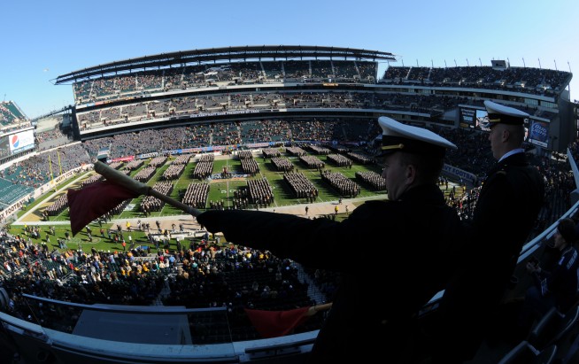 PHILADELPHIA (Dec. 12, 2009) Midshipman 2nd Class Jason Beasley, left, from China Lake, Calif, and Midshipman 1st Class Michael Ross, from Nashville, direct the Brigade of Midshipmen as they enter the stadium for the 110th Army-Navy college football game at Lincoln Financial Field in Philadelphia. U.S. Navy photo by Damon J. Moritz. Caption: U.S. Navy. 