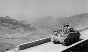 A Sherman tank moves past Sicily's rugged terrain. Image credit: National Archives. Caption credit: Center of U.S. Military History
