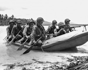 Marine Raitders practice beach assaults in a rubber raft. Note the Marine on the bow of the raft providing security with a Browning automatic rifle (BAR). Caption credit: MARSOC by Fred Pushies. Image credit: USMC PHOTO