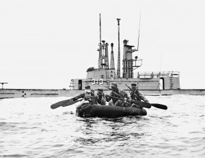Page 34: A Scouwt patrol of the Marine Amphibious Reconnaissance Company departs in rubber boats from the submarine USS Perch during Operation Ski Jump, January 1957. Caption credit: MARSOC by Fred Pushies. Image credit: USMC HISTORY DIVISION, QUANTICO.