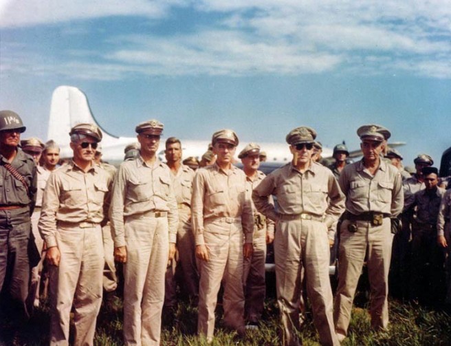 General of the Army Douglas MacArthur, U.S. Army (second from right) with other senior Army officers, upon his arrival at Atsugi airdrome, near Tokyo, Japan, 30 August 1945. Among those present are: Major General Joseph M. Swing, Commanding General, 11th Airborne Division, (left); Lieutenant General Richard K. Sutherland (3rd from right); General Robert L. Eichelberger (right). Aircraft in the background is a Douglas C-54. Credit: Naval Historical Center.