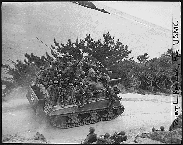 Tank borne infantry moving up to take the town of Ghuta before the Japanese can occupy it