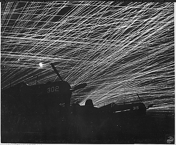 Japanese night raiders are greeted with a lacework of anti aircraft fire by the Marine defenders