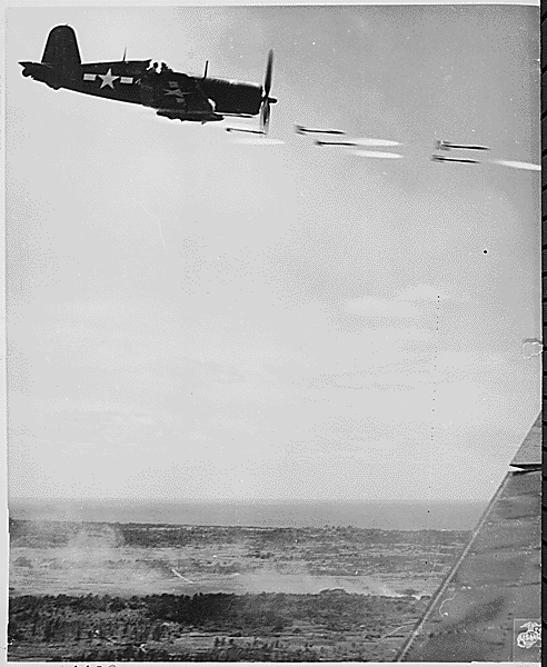 Corsair fighter looses its load of rocket projectiles on a run against a Jap stronghold on Okinawa