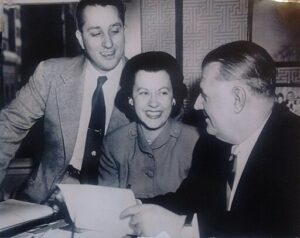 Giles E. Miller and his wife, Betty, complete purchase of franchise to be called Dallas Texans with NFL Commissioner, Bert Bell, January 1952. Courtesy of Wikimedia. Public Domain.