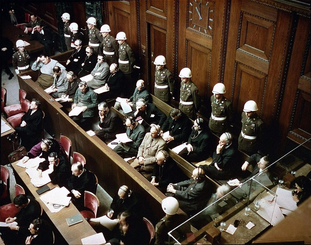 View of the defendants in the dock at the International Military Tribunal trial of war criminals in Nuremberg, Bavaria, Germany. November 1945. Public domain. Courtesy of Wikimedia.