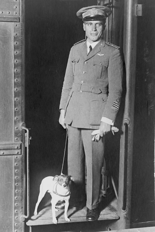 Umberto Nobile, full-length portrait, dressed in military uniform standing in a doorway with his dog, Titina. Copyright Library of Congress. Courtesy of Wikimedia Commons.